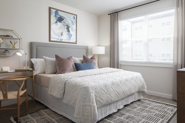 Cozy bedroom with modern decor at Prose District West Apartments