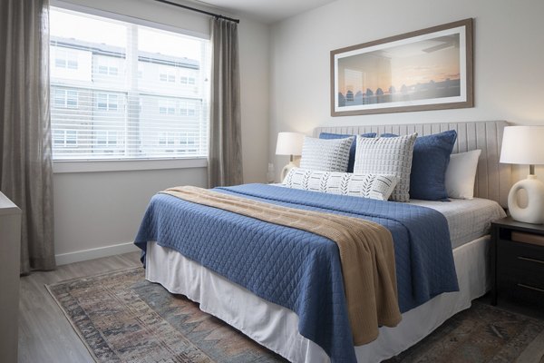 Cozy bedroom with modern furnishings in Prose District West Apartments