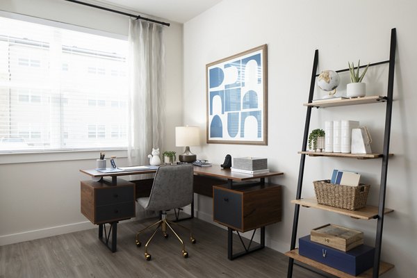 Home office with ergonomic desk and natural light in Prose District West Apartments
