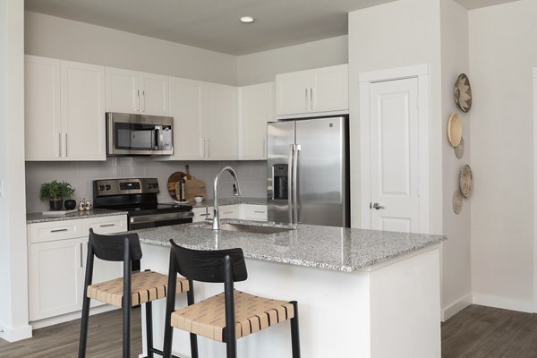 Modern kitchen with sleek countertops and stainless steel appliances at Prose District West Apartments, perfect for contemporary living