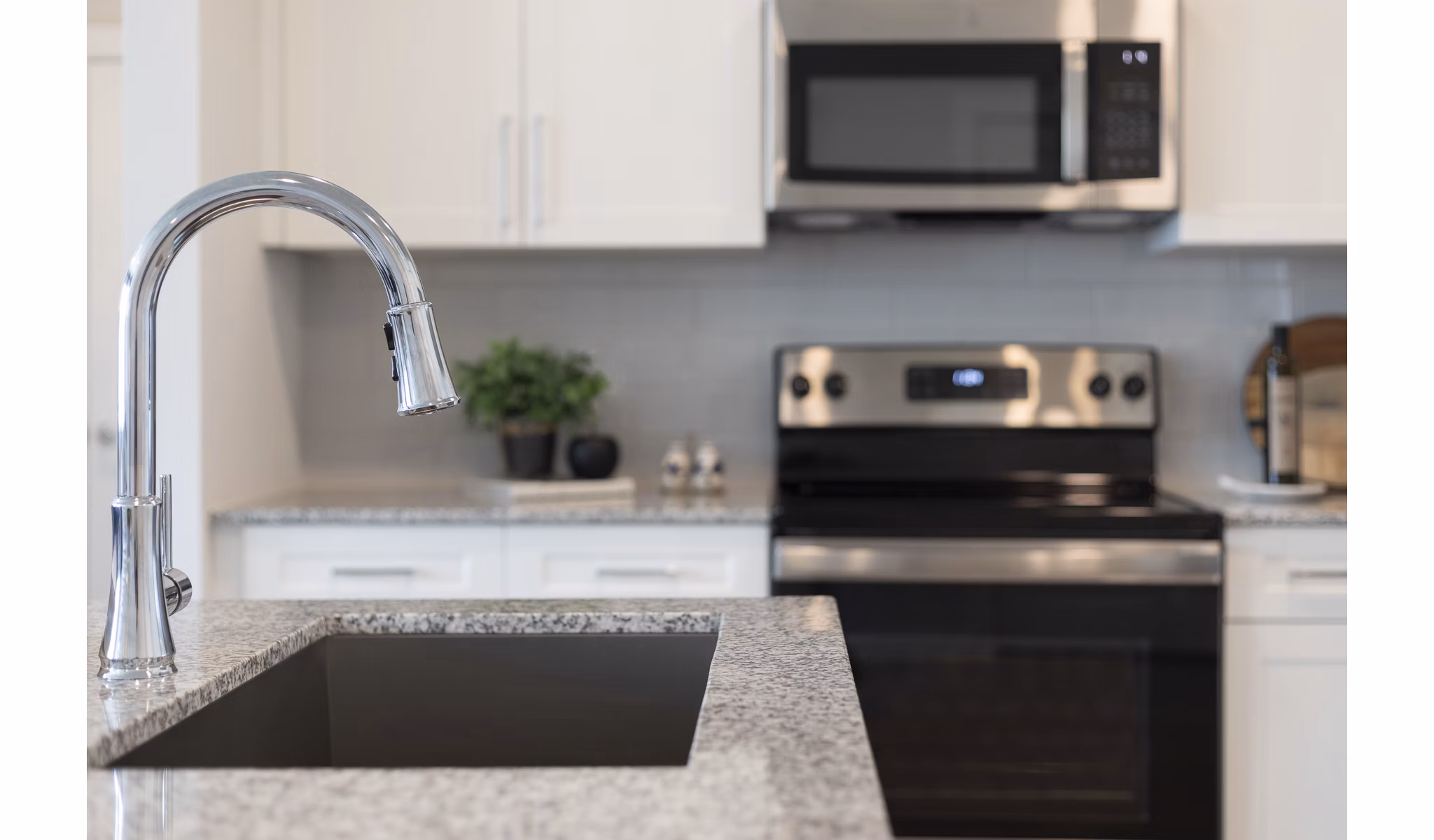 Modern kitchen with sleek countertops and stainless steel appliances at Prose District West Apartments