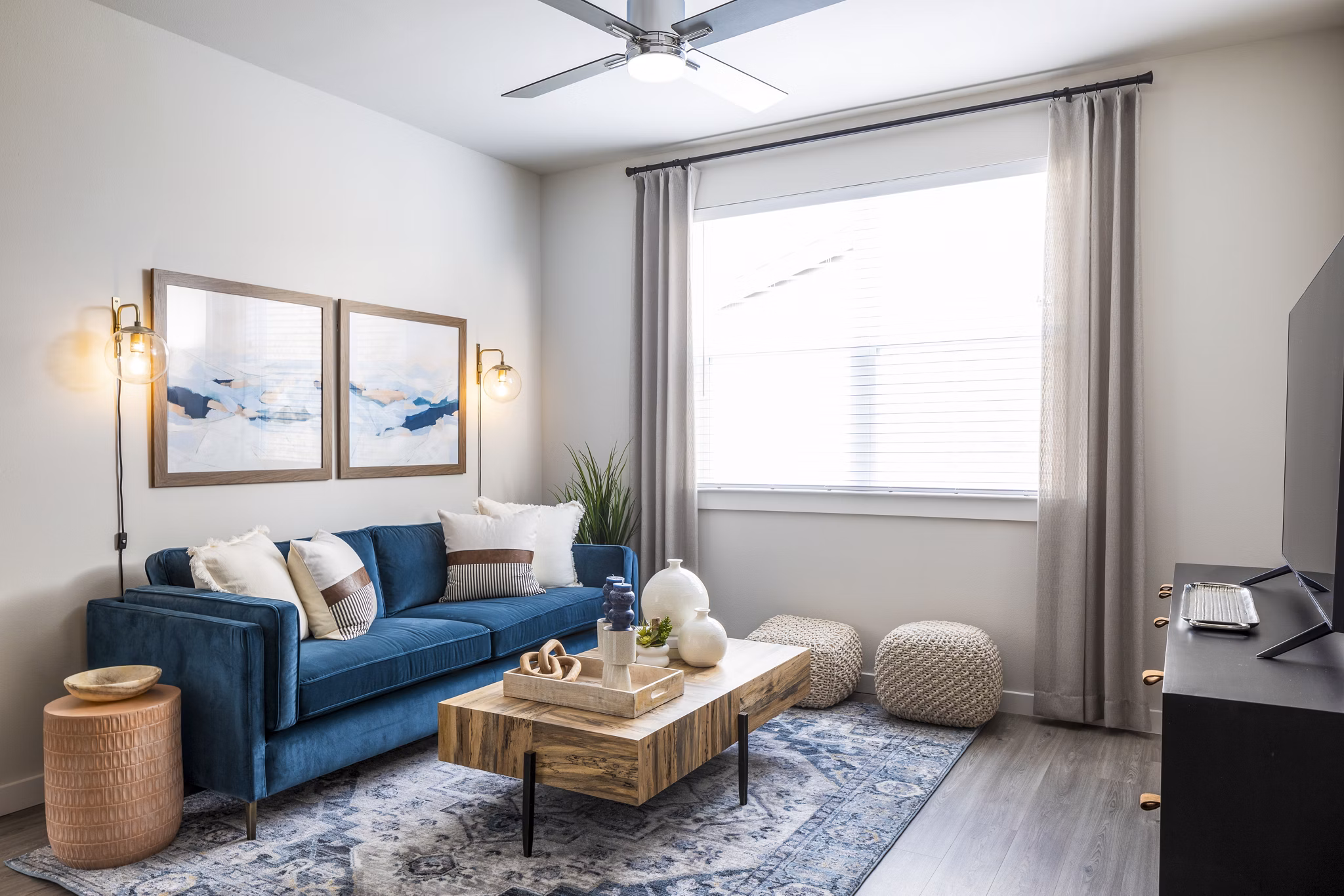 Living room with modern decor and ample natural light at Prose District West Apartments, luxury living at its finest