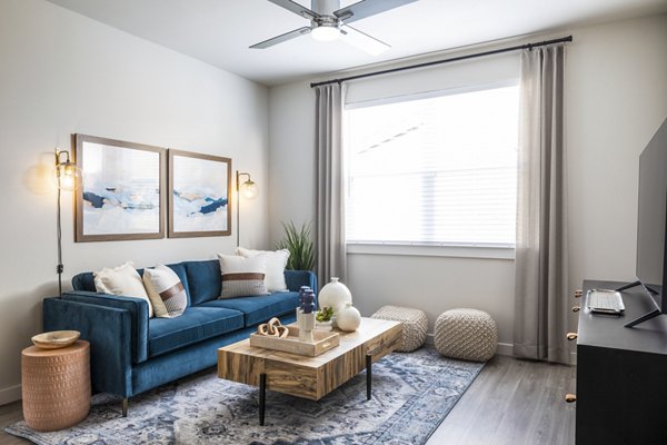 Living room with modern decor and ample natural light at Prose District West Apartments, luxury living at its finest