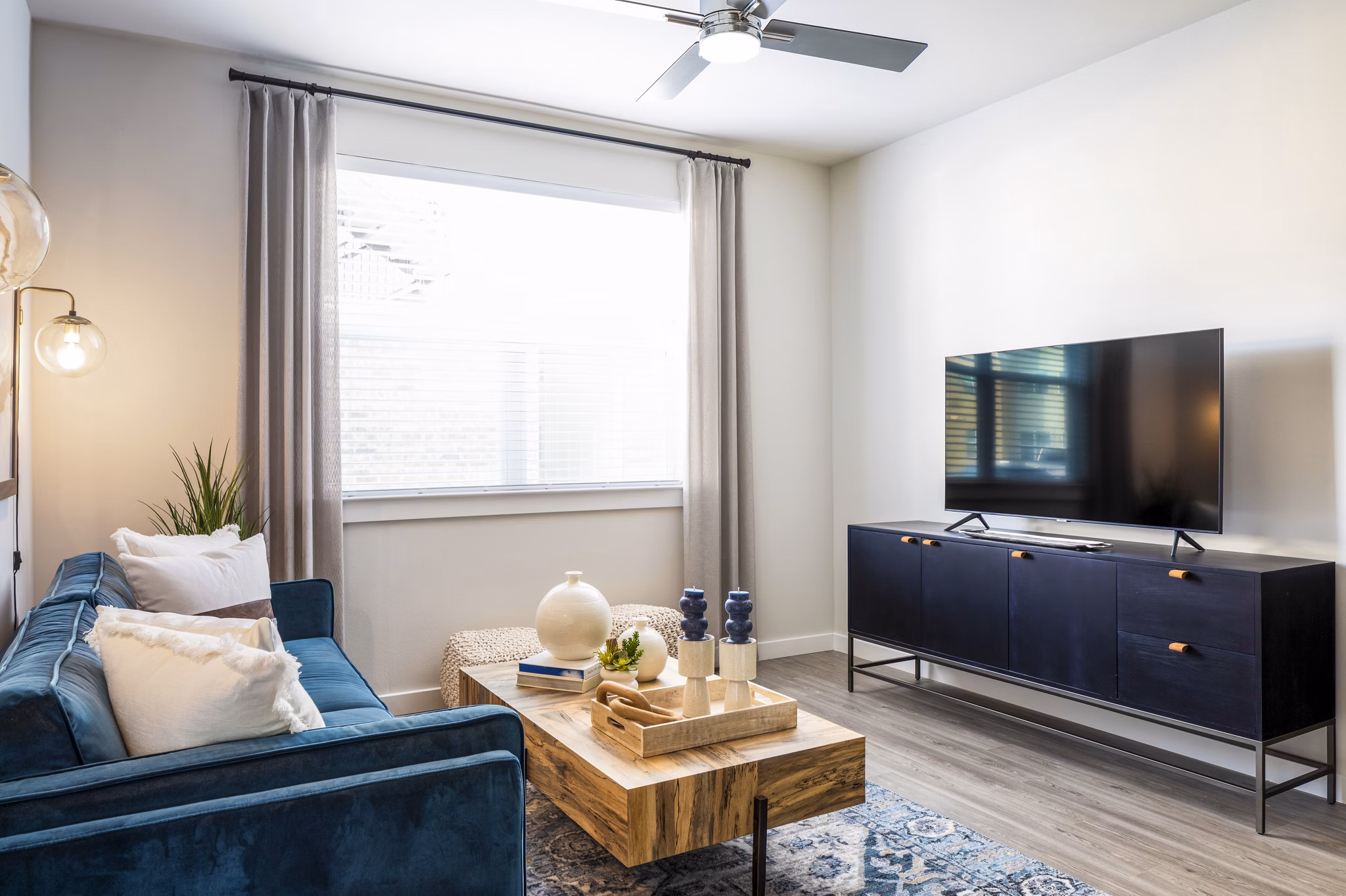 Open-concept living room with modern furnishings in Prose District West Apartments