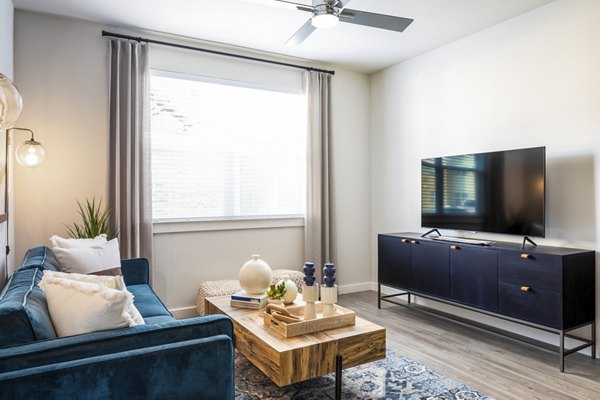 Open-concept living room with modern furnishings in Prose District West Apartments