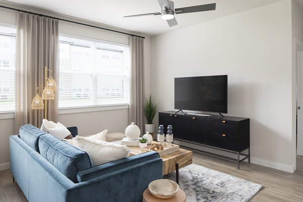 Living room with modern decor and ample natural light at Prose District West Apartments