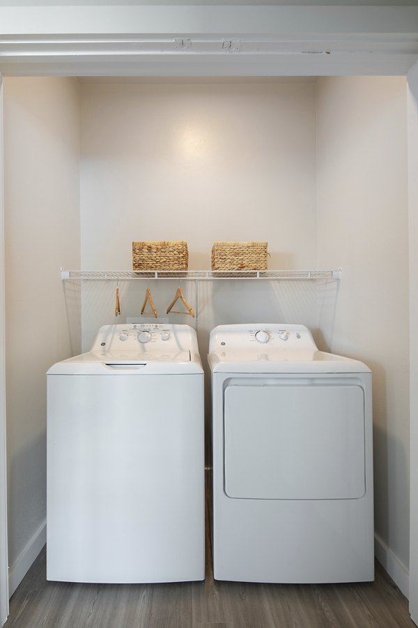 Modern laundry room with energy-efficient washers and dryers at Prose District West Apartments, offering convenience and comfort in every detail