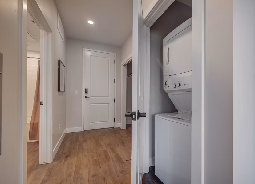 Contemporary hallway with sleek lighting and modern art at Bowers Apartments