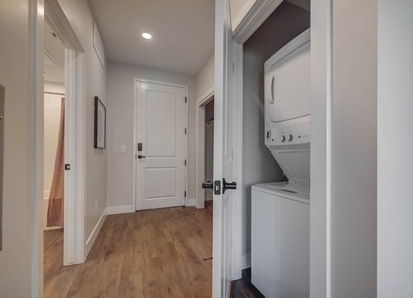 Contemporary hallway with sleek lighting and modern art at Bowers Apartments