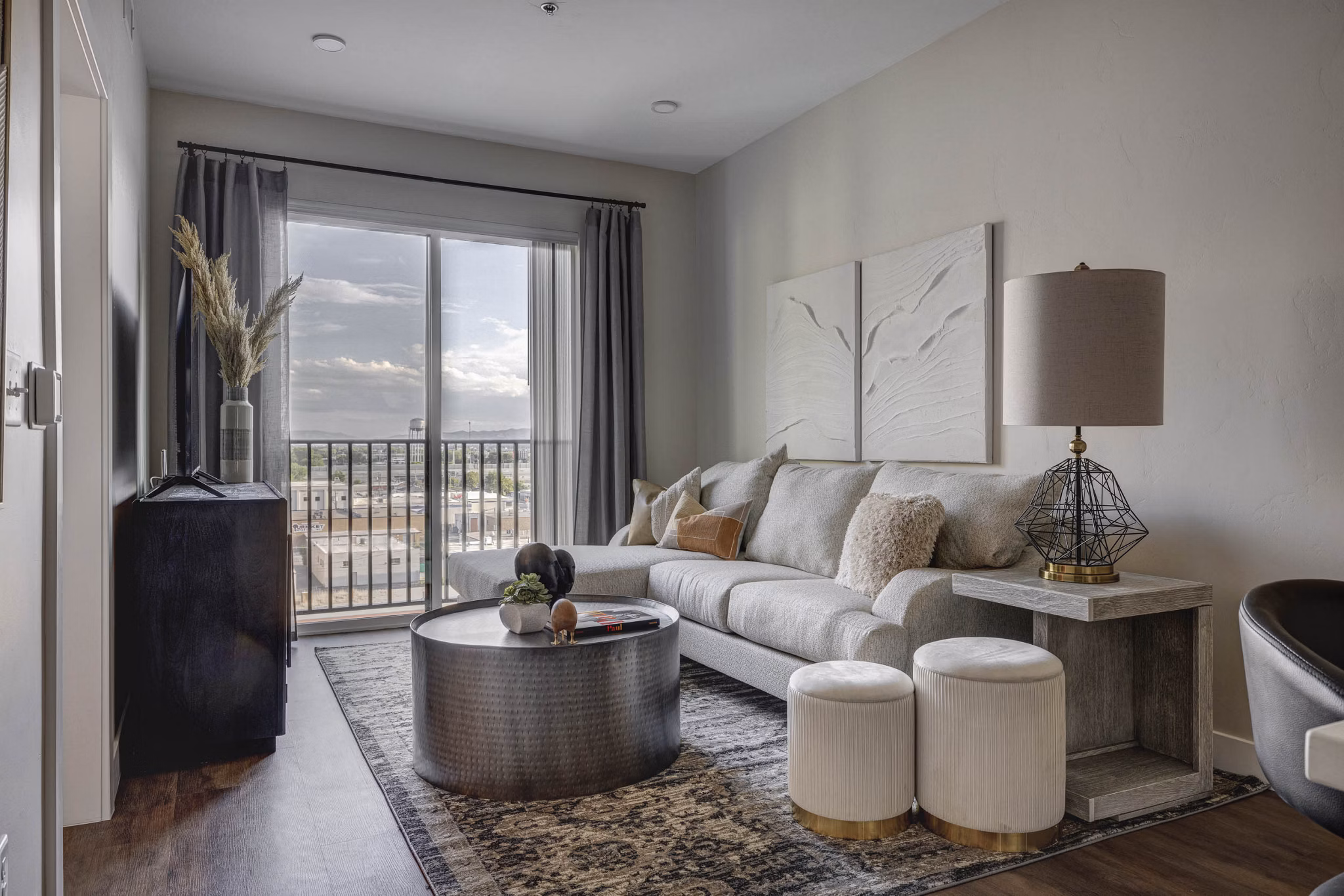Living room with modern decor and natural light at Bowers Apartments