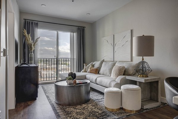 Living room with modern decor and natural light at Bowers Apartments