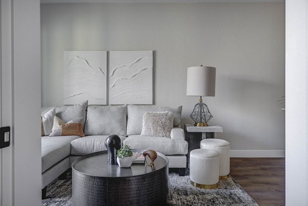 Modern living room with stylish decor and large windows at Bowers Apartments