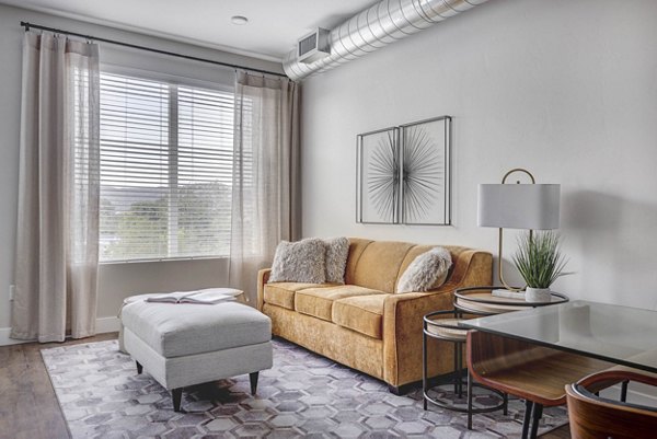 Modern living room with sleek furniture and natural light at Bowers Apartments