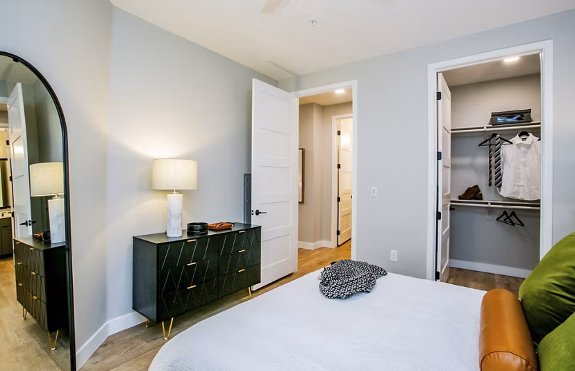 Elegant bedroom featuring modern decor and large windows in Tanager Echo Apartments