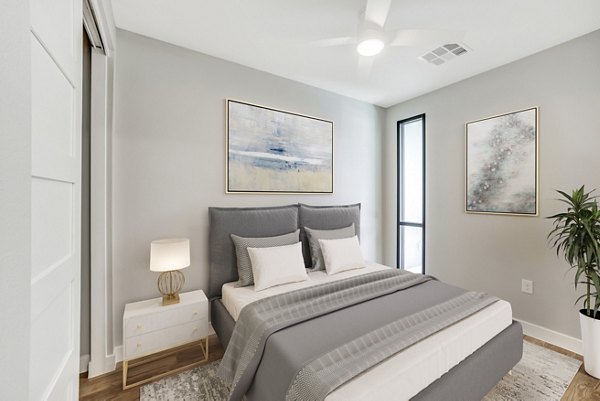 Tanager Echo Apartments: Contemporary bedroom with stylish decor and expansive windows