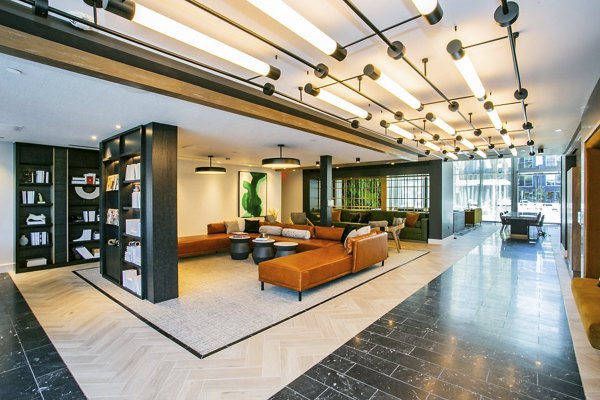 Clubhouse with modern furnishings and vibrant decor at Tanager Echo Apartments, a Greystar luxury community