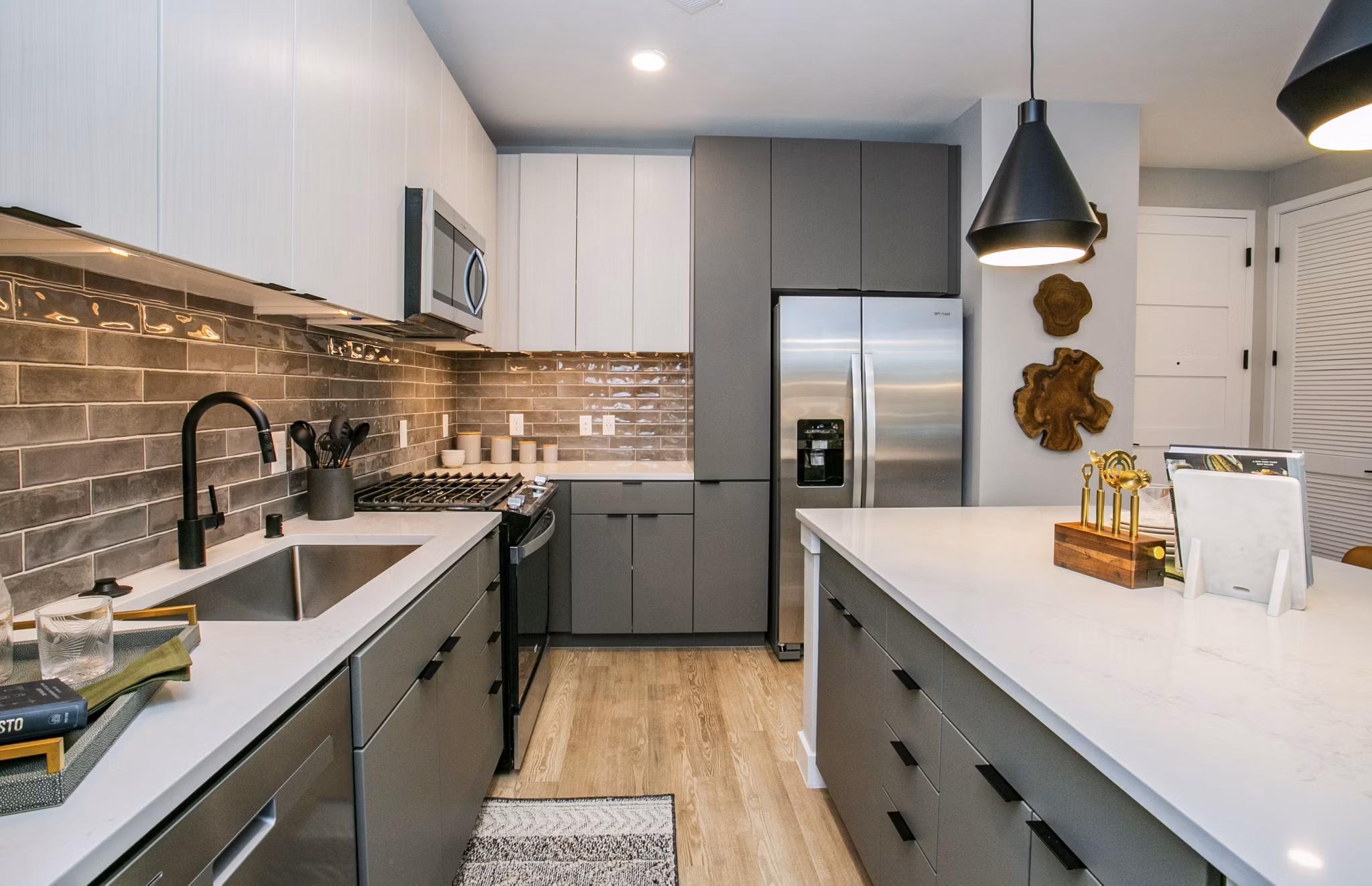 Tanager Echo Apartments: Modern kitchen with stainless steel appliances and granite countertops