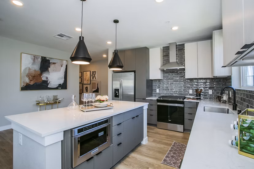 Modern kitchen with stainless steel appliances at Tanager Echo Apartments