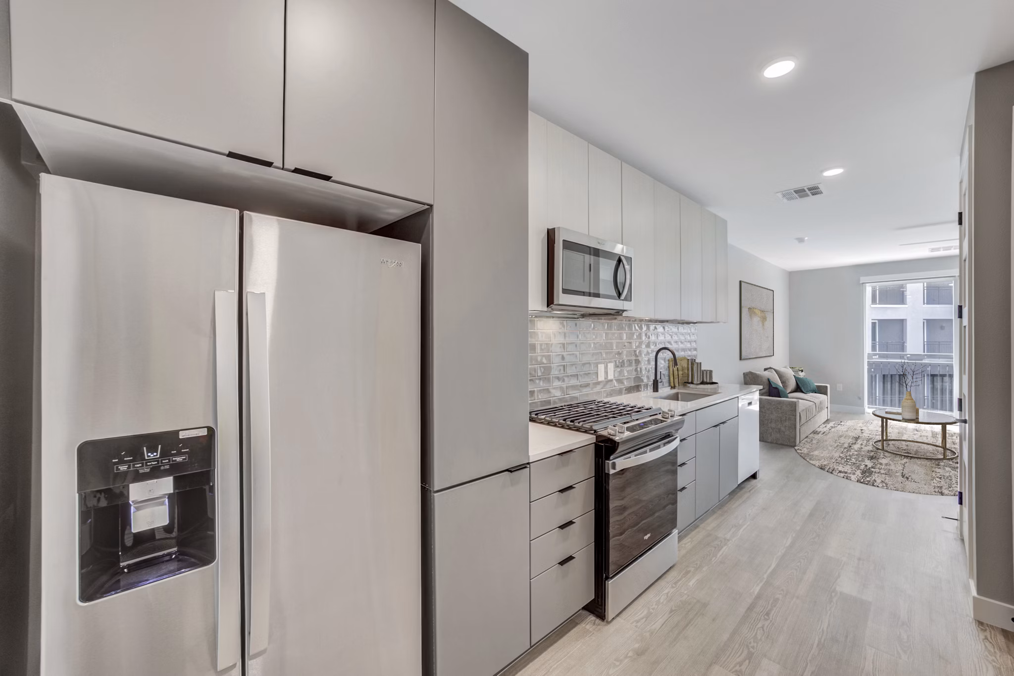 Modern kitchen featuring sleek countertops and stainless steel appliances at Tanager Echo Apartments