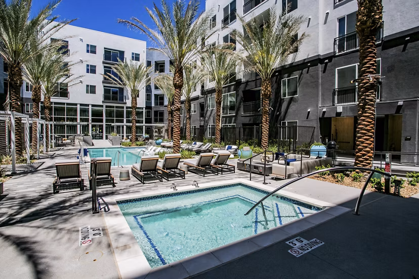 Resort-style pool with lounge chairs at Tanager Echo Apartments for luxury living