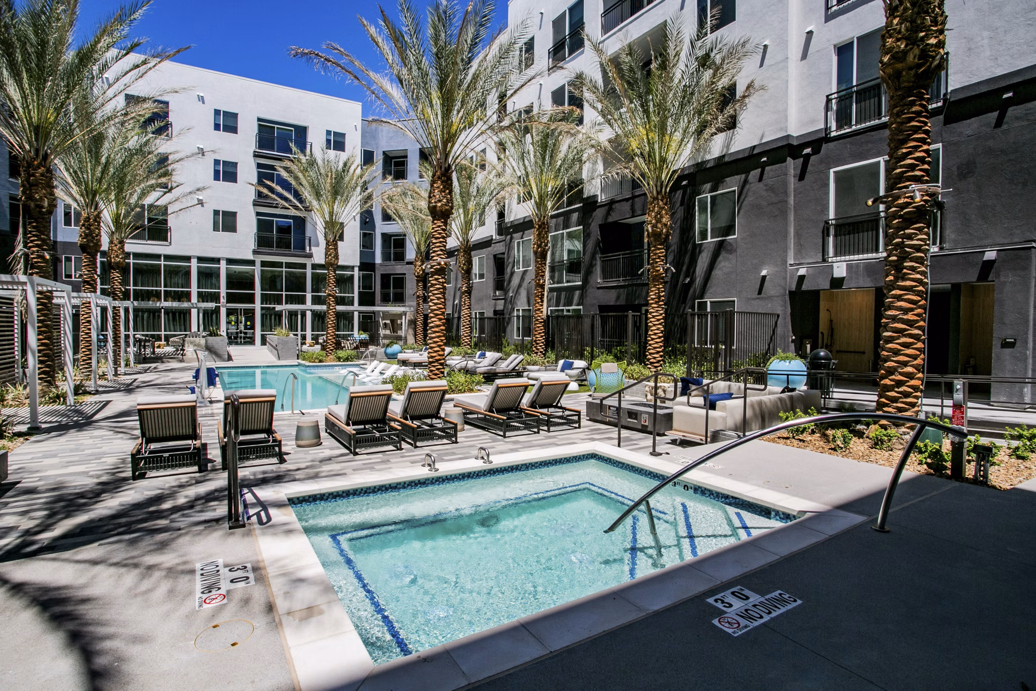Resort-style pool with lounge chairs at Tanager Echo Apartments for luxury living