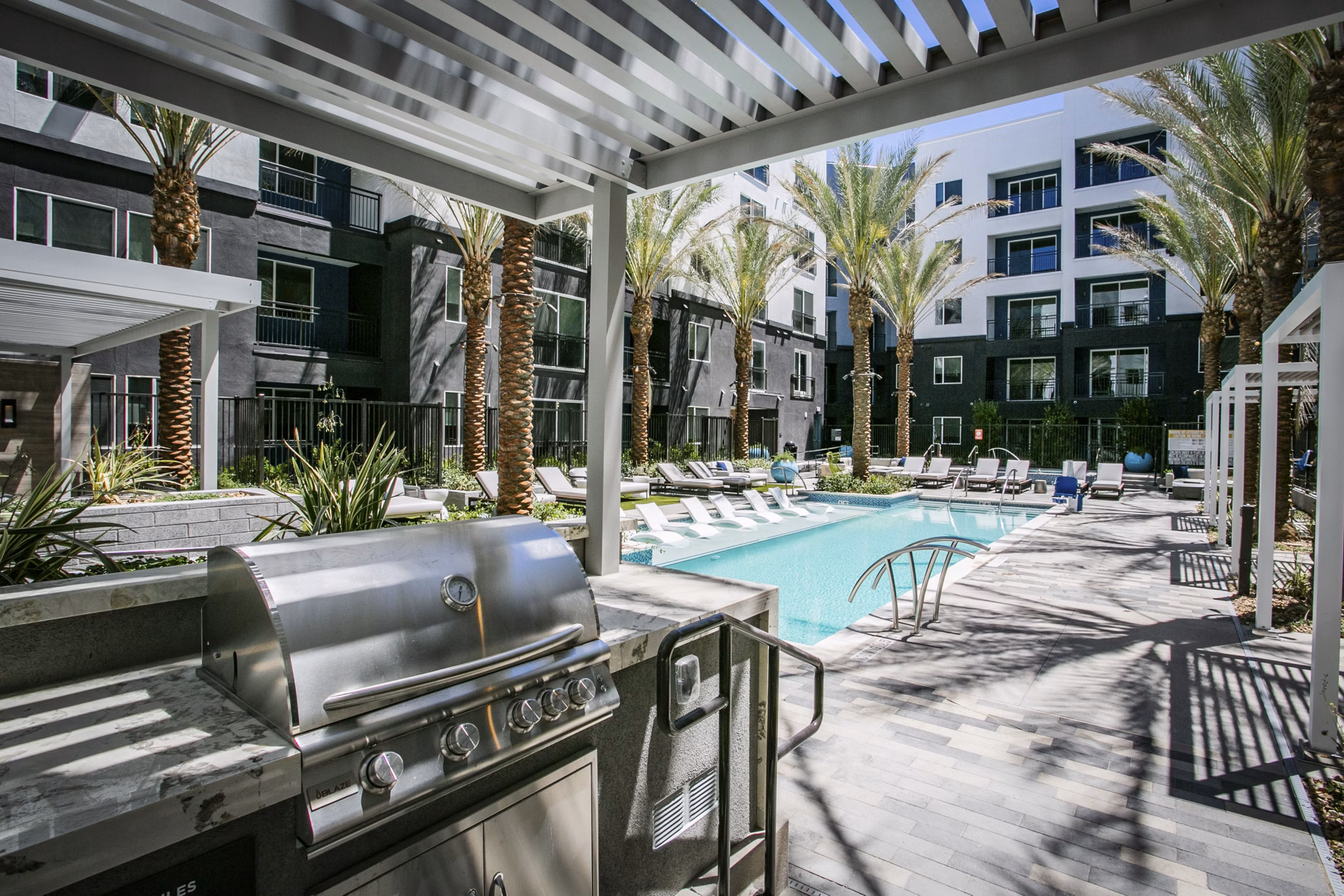 Outdoor grill area with modern seating at Tanager Echo Apartments, part of Greystar's luxury apartment communities
