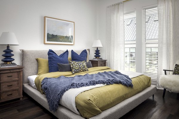 Modern bedroom with stylish decor at Adaline at the Station Apartments