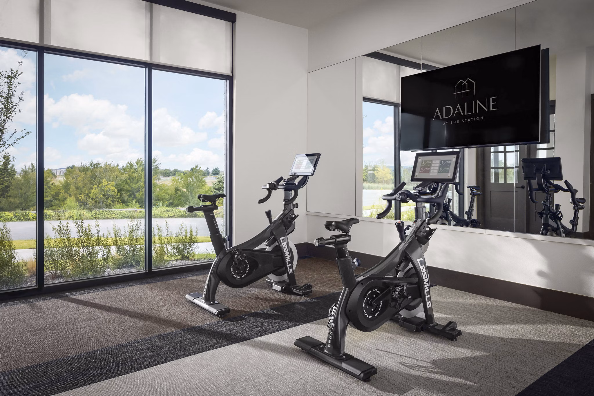 Yoga and spin studio with state-of-the-art equipment at Adaline at the Station Apartments offering luxury fitness amenities
