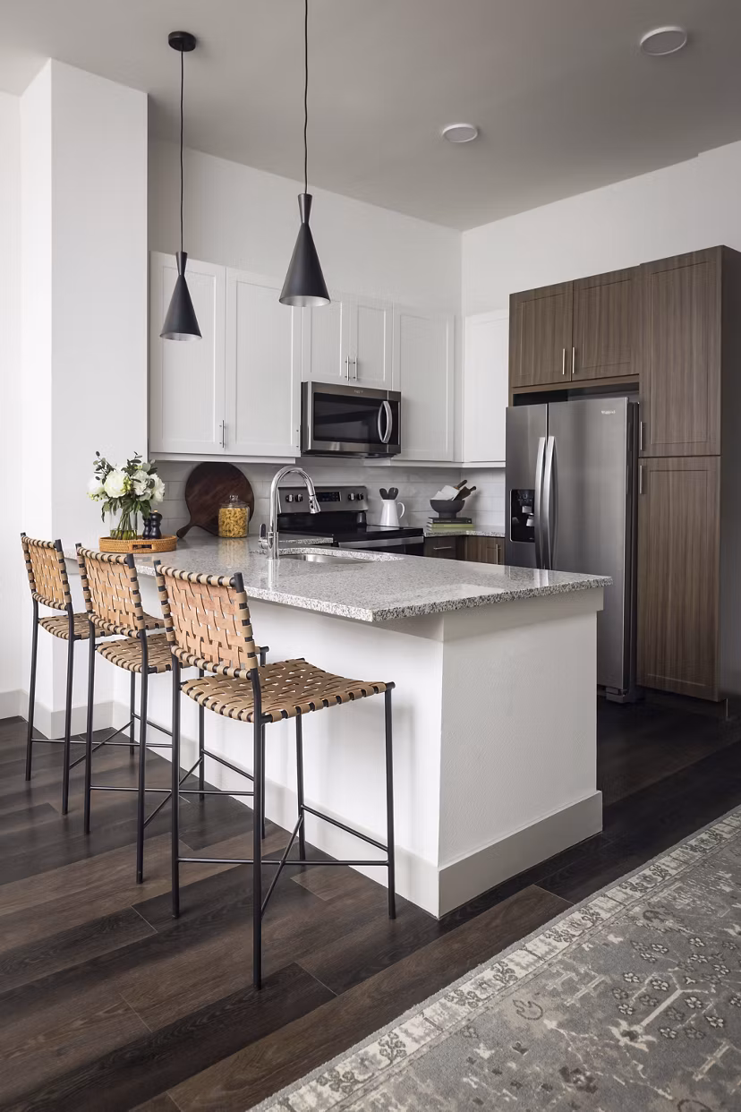 Modern kitchen with sleek countertops and stainless-steel appliances in Adaline at the Station Apartments