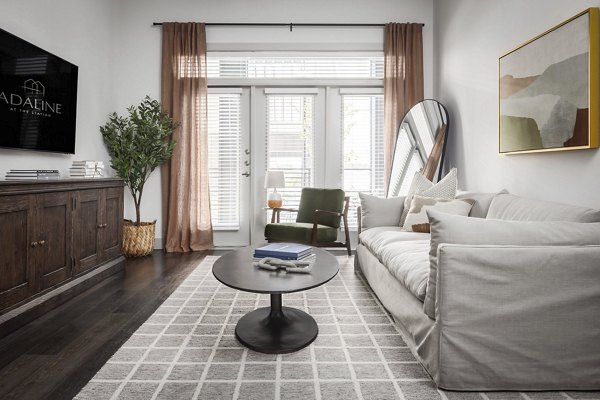 Spacious living room with modern decor in Adaline at the Station Apartments
