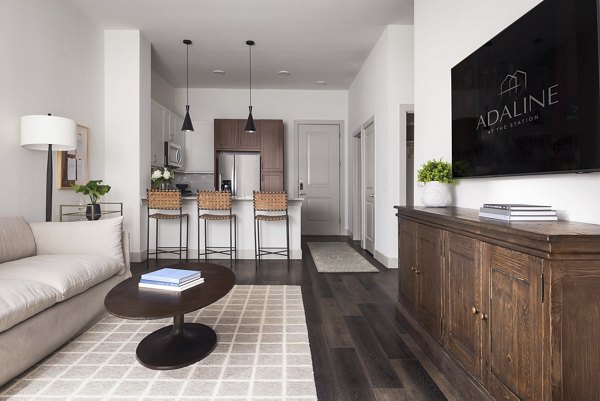 Spacious living room with modern decor in Adaline at the Station Apartments