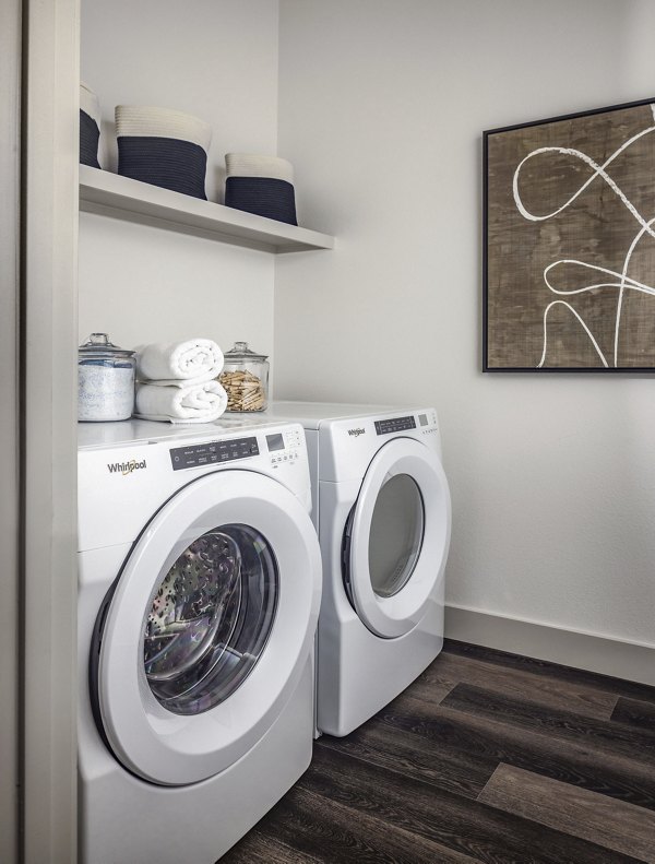Laundry room with modern appliances at Adaline at the Station Apartments
