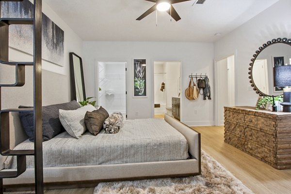 Cozy bedroom with queen bed and modern decor at Adara at Godley Station Apartments