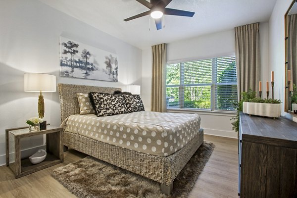 Bedroom featuring contemporary decor and cozy ambiance at Adara at Godley Station Apartments