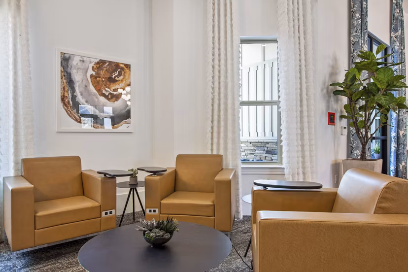 Clubhouse featuring modern design and cozy seating at Adara at Godley Station Apartments, perfect for socializing and relaxation