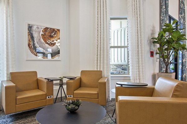 Clubhouse featuring modern design and cozy seating at Adara at Godley Station Apartments, perfect for socializing and relaxation