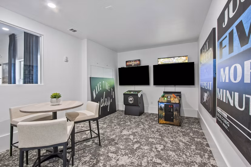Game room with billiards and arcade games at Adara at Godley Station Apartments offering entertainment and fun for residents