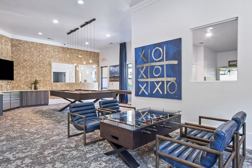 Game room featuring pool table and lounge seating at Adara at Godley Station Apartments