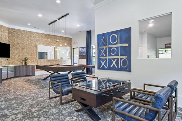 Game room featuring pool table and lounge seating at Adara at Godley Station Apartments