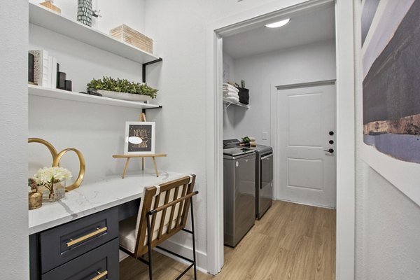 Home office with modern desk and chair at Adara at Godley Station Apartments
