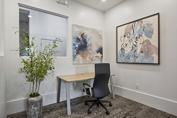 Home office featuring ergonomic desk and large window in Adara at Godley Station Apartments