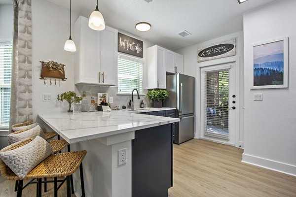 Adara at Godley Station: Modern kitchen with stainless steel appliances in luxury apartments
