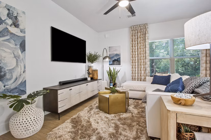 Spacious living room with modern furnishings in Adara at Godley Station Apartments
