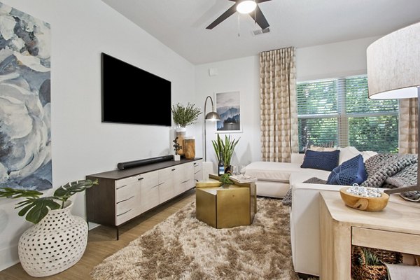 Spacious living room with modern furnishings in Adara at Godley Station Apartments