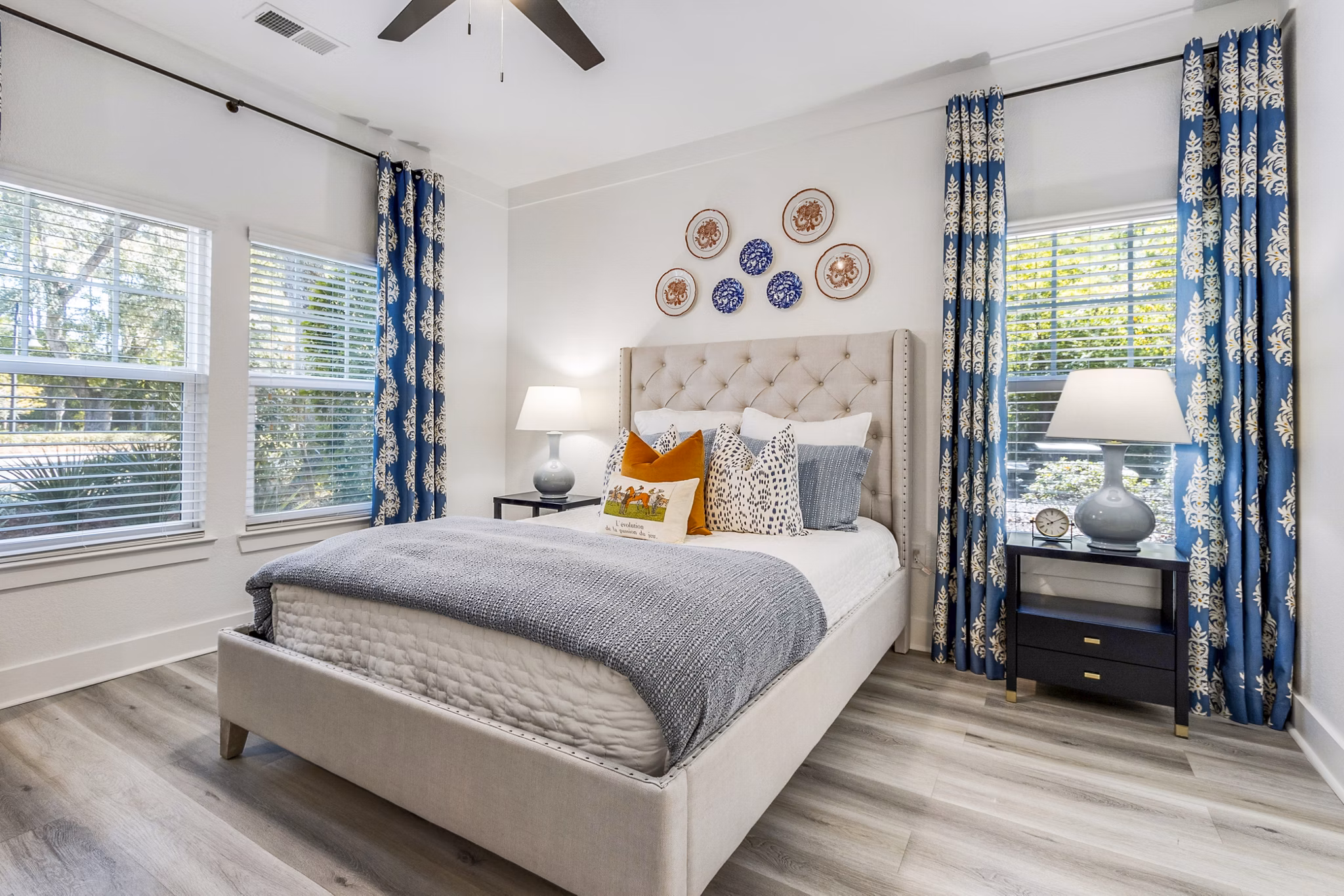 Cozy bedroom with modern decor at The Avenues at Verdier Pointe Apartments, showcasing luxury living spaces by Greystar