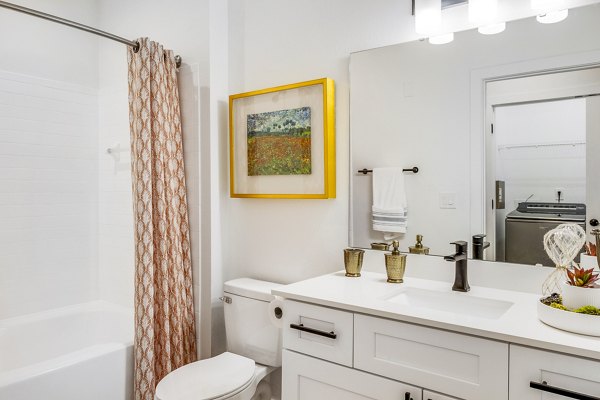 Modern bathroom with elegant tilework and sleek fixtures at The Avenues at Verdier Pointe Apartments