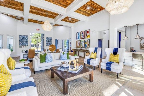 Clubhouse featuring modern design and spacious seating at The Avenues at Verdier Pointe Apartments