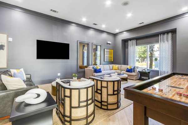 Clubhouse game room with pool table and lounge seating at The Avenues at Verdier Pointe Apartments