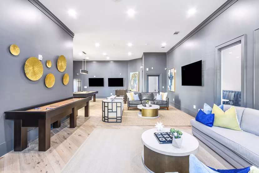 Clubhouse game room with billiards table and cozy seating at The Avenues at Verdier Pointe Apartments