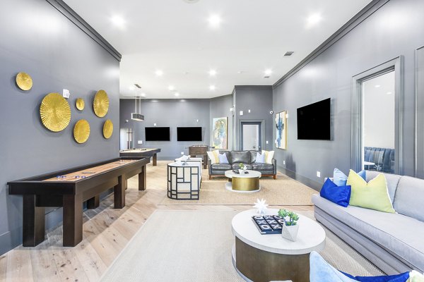 Clubhouse game room with billiards table and cozy seating at The Avenues at Verdier Pointe Apartments